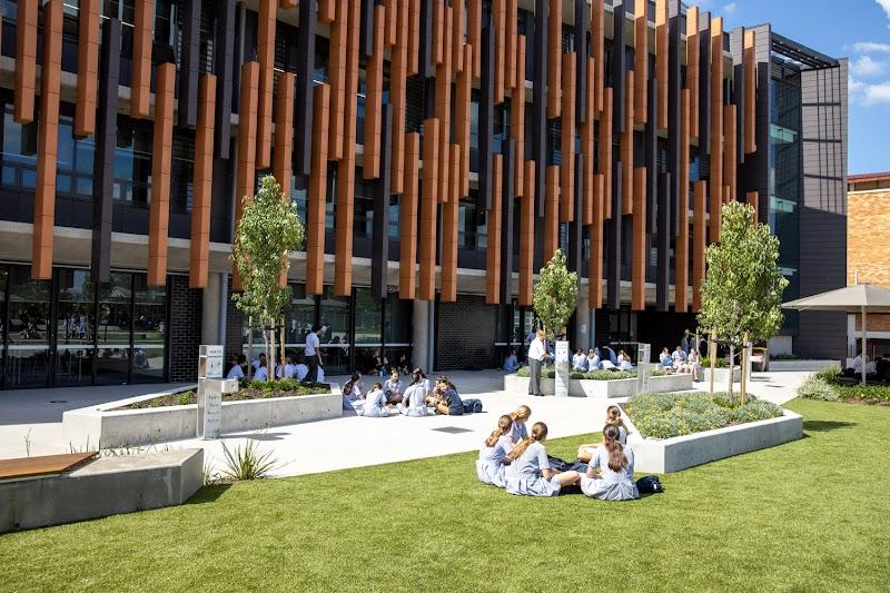 Students on the grounds of a modern independent school campus